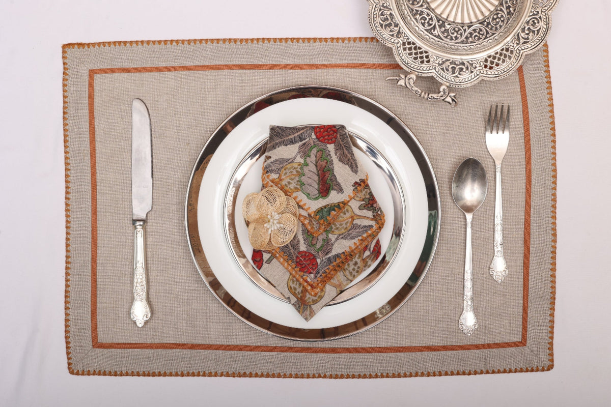 Natural linen embroidered placemats and printed linen napkin.
