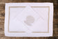 White linen placemats and napkins with gold hydrangea.