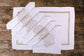 White linen placemats and napkins with gold hydrangea.