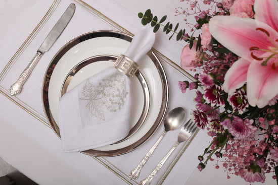 White linen placemats and napkins with gold hydrangea.