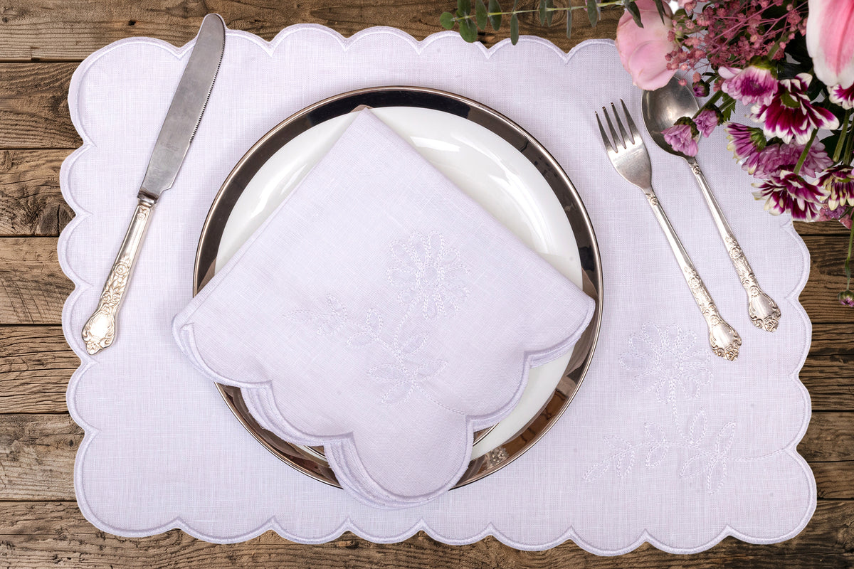 White linen placemat and napkin embroidered.