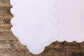 White linen placemat and napkin embroidered.