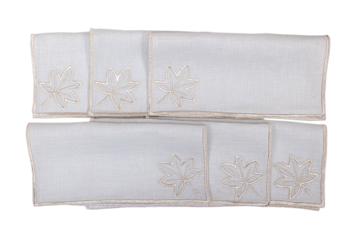 Powder blue linen silver maple leaf embroidered cocktail napkin.