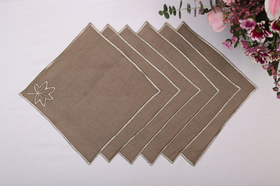 Brown linen maple leaf embroidered cocktail napkin.