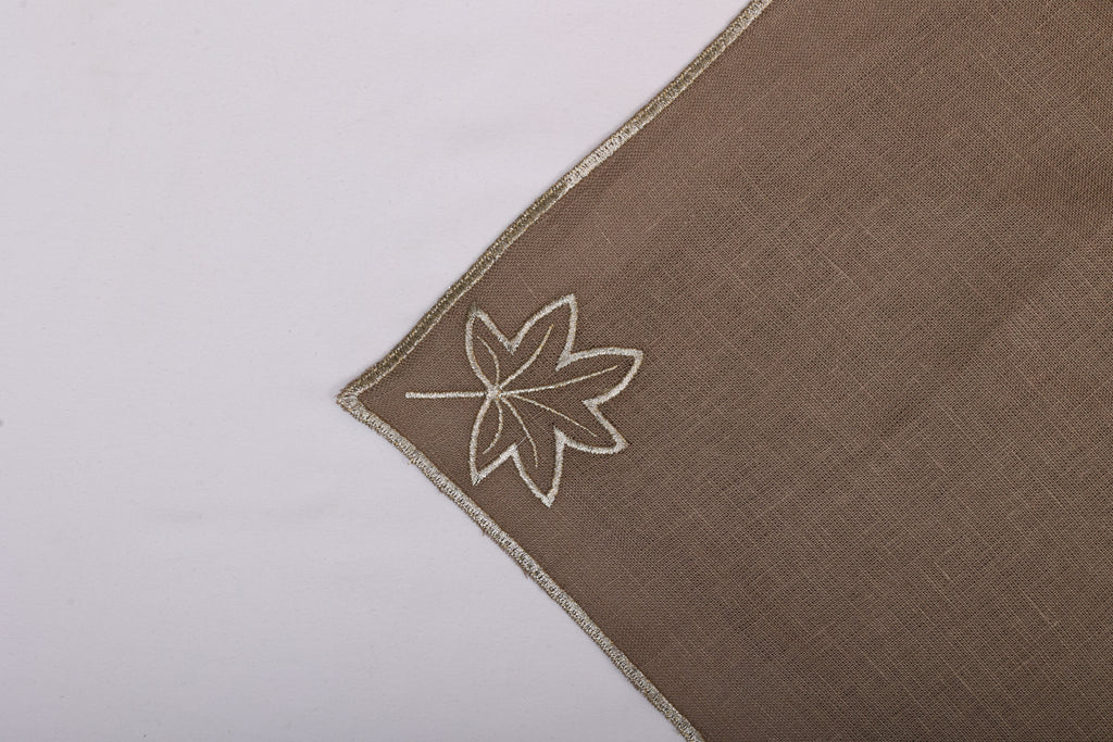 Brown linen maple leaf embroidered cocktail napkin.