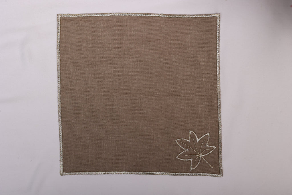 Brown linen maple leaf embroidered cocktail napkin.