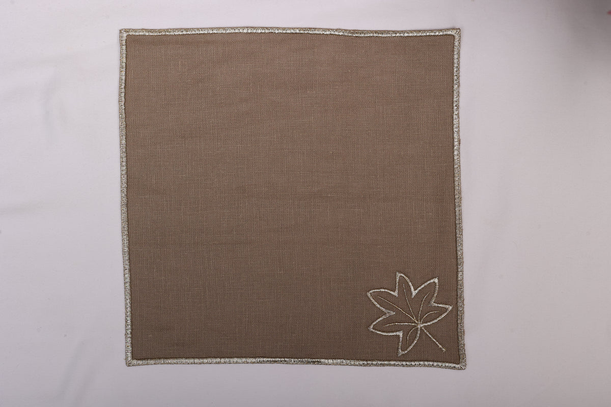 Brown linen maple leaf embroidered cocktail napkin.