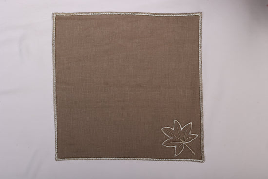 Brown linen maple leaf embroidered cocktail napkin.