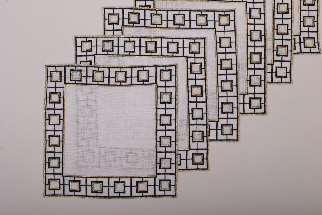 White linen embroidered cocktail napkin.