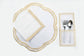 White linen gold embroidered round placemats and napkins.