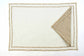 Embroidered cream linen placemats with  beige striped linen napkins.