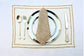 Embroidered cream linen placemats with  beige striped linen napkins.