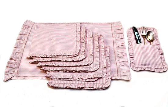 Pink striped linen placemats and napkins with ruffles.