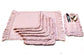 Pink striped placemats and napkins with ruffles.