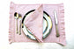 Pink striped linen placemats and napkins with ruffles.