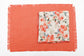 Rust peach linen placemats with floral printed linen napkins.