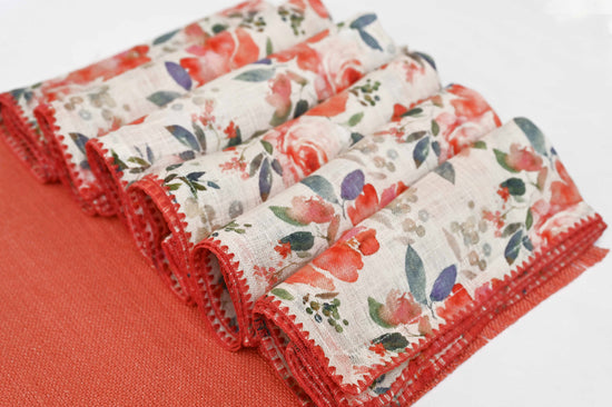 Rust peach linen placemats with floral printed linen napkins.