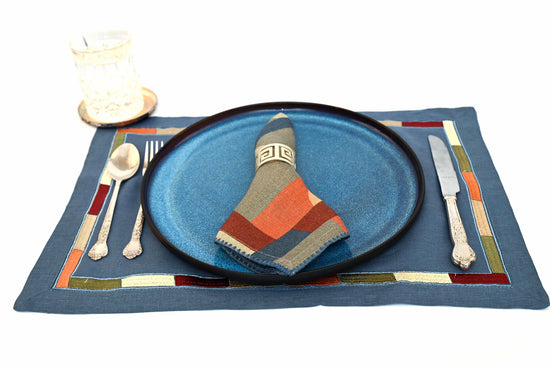 Slate blue linen placemats with  printed linen napkins.