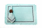 Aqua blue linen  placemats with  striped linen napkins.