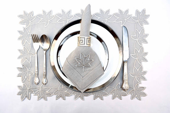 Grey linen placemats and napkins with silver embroidered linen napkins.