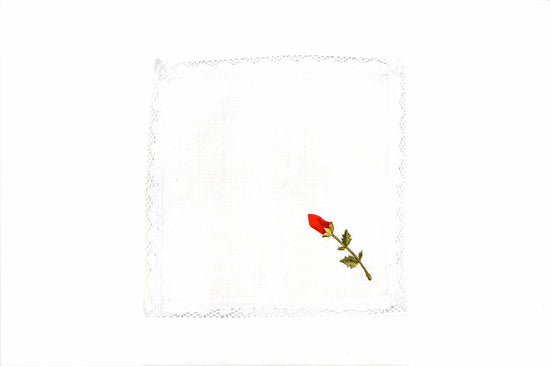 White linen cocktail napkins with rosebud embroidery.