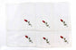 White linen dinner napkins with rosebud embroidery.