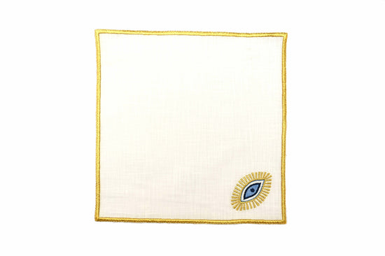 White linen cocktail napkins with gold evil eye embroidered.