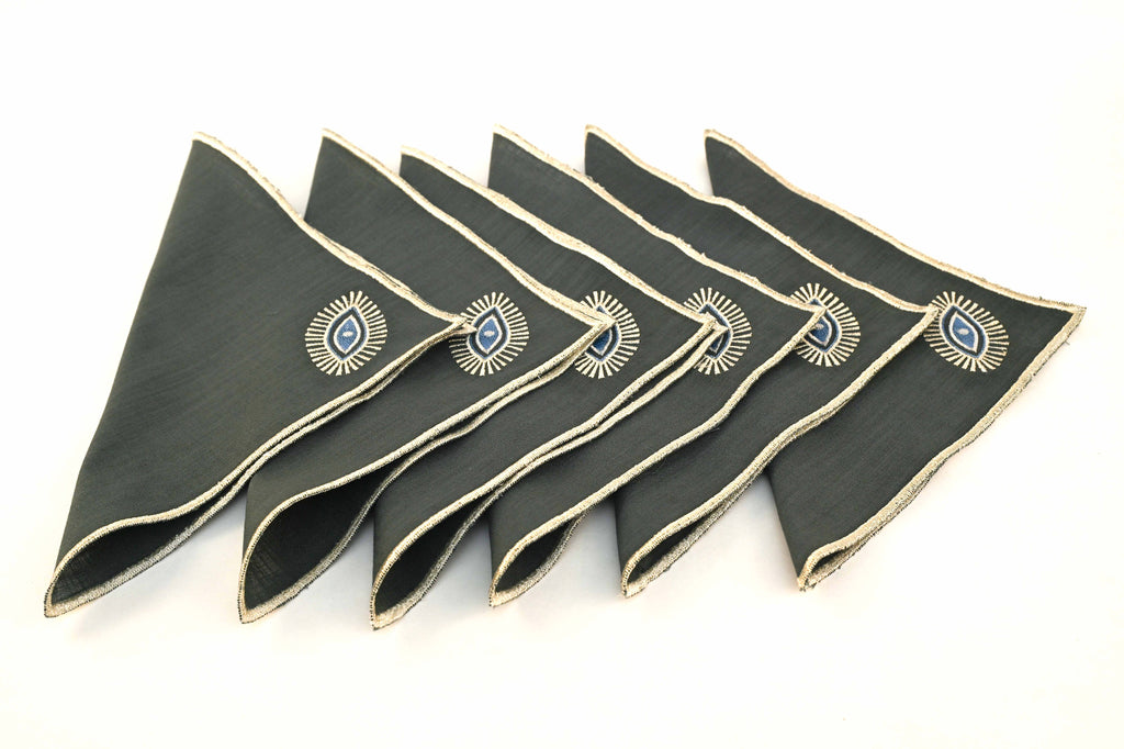 Charcoal grey linen cocktail napkins with silver evil eye embroidered.