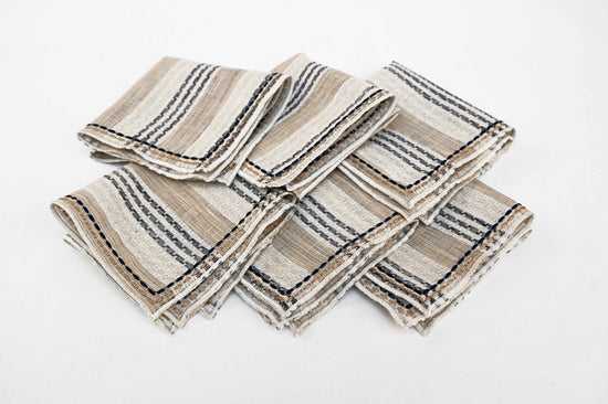 Beige striped linen cocktail napkins.