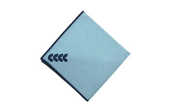 Blue cotton dinner napkins with leaves embroidered.