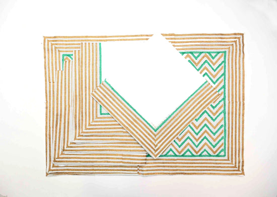 White linen placemats and napkins with turquoise chevron print all over.