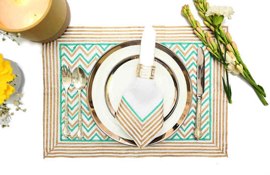 White linen placemats and napkins with turquoise chevron print all over.