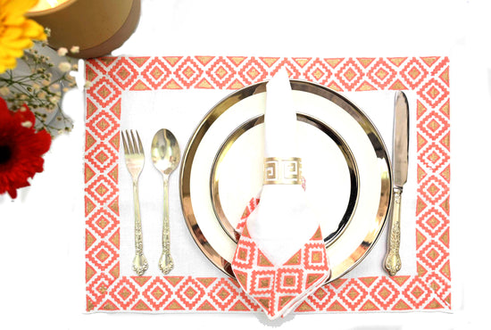 White linen placemats and napkins with pink  block print.