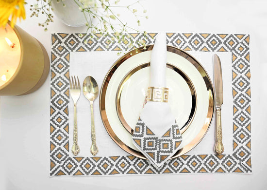 White linen placemats and napkins with grey block print.