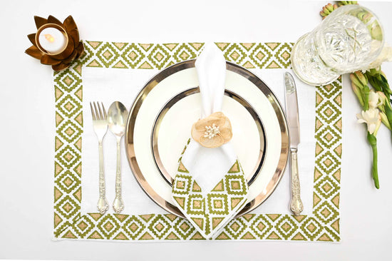 White linen placemats and napkins with olive  block print.