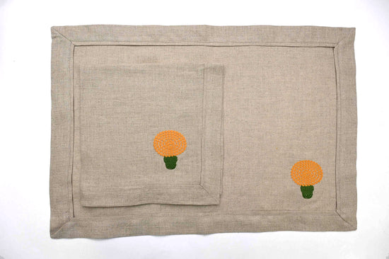Natural linen placemats and napkins with marigold embroidery.