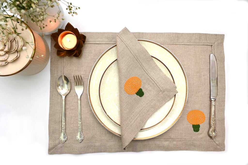 Natural linen placemats and napkins with marigold embroidery.