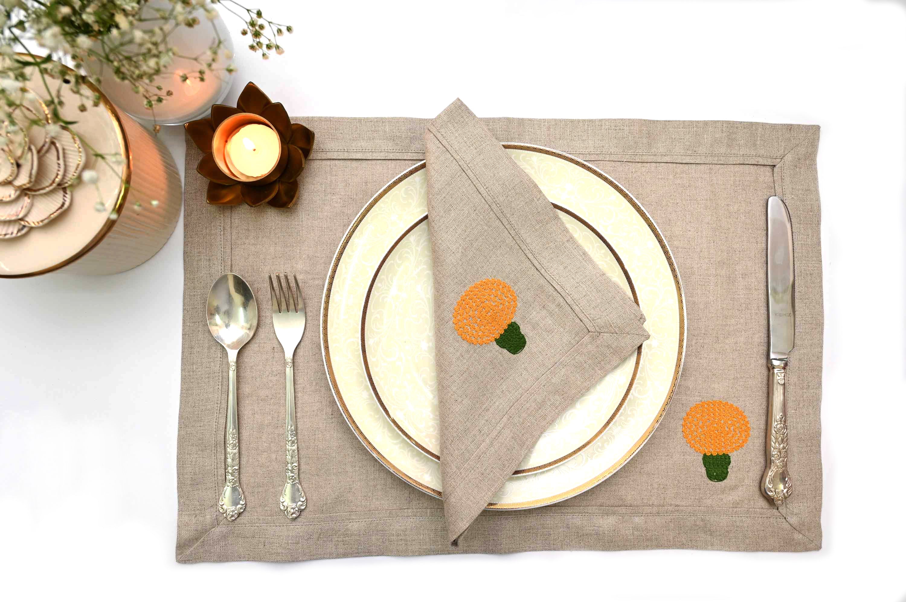 Natural linen placemats and napkins with marigold embroidery.
