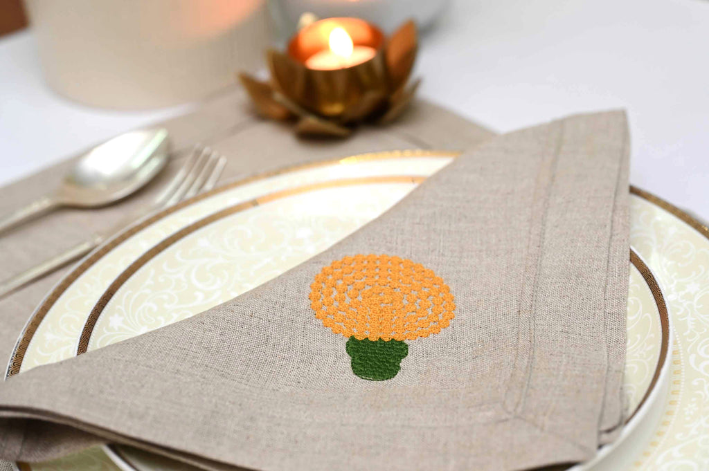 Natural linen placemats and napkins with marigold embroidery.