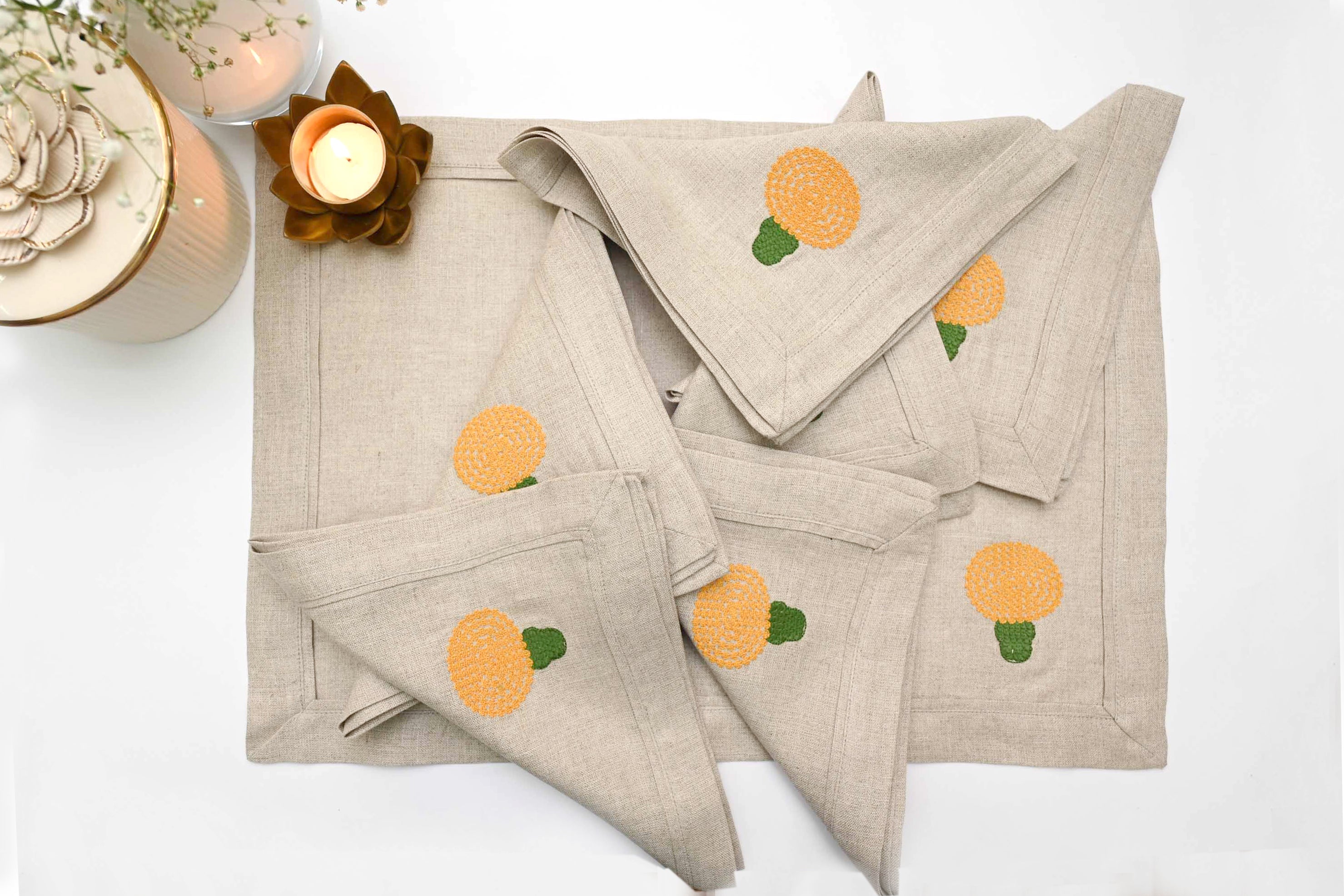 Natural linen placemats and napkins with marigold embroidery.