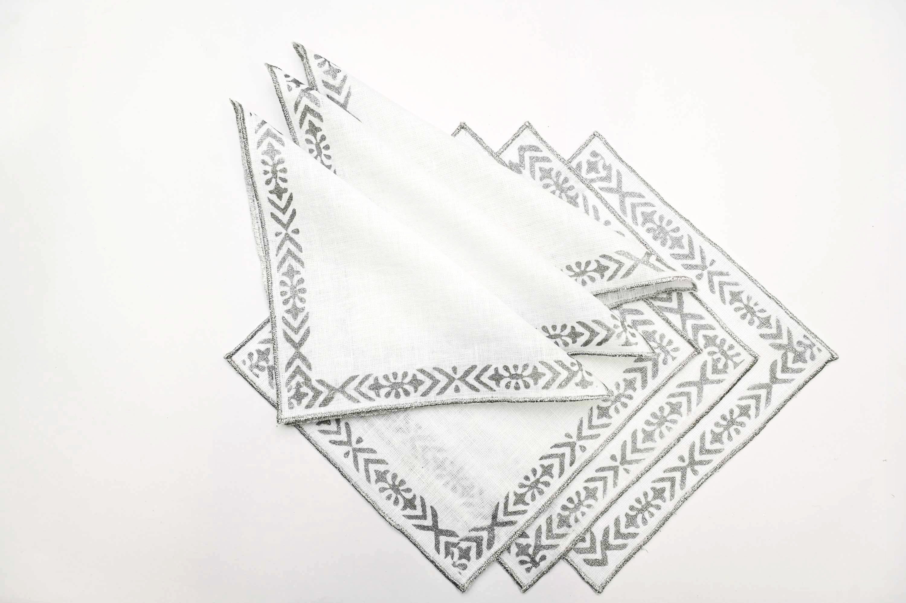 Linen cocktail napkins with line and motif.