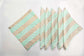 Turquoise chevron print linen cocktail napkins.