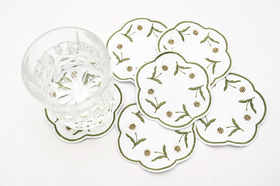White linen round embroidered coasters.