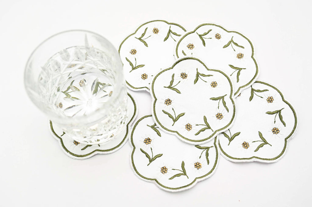 White linen round embroidered coasters.