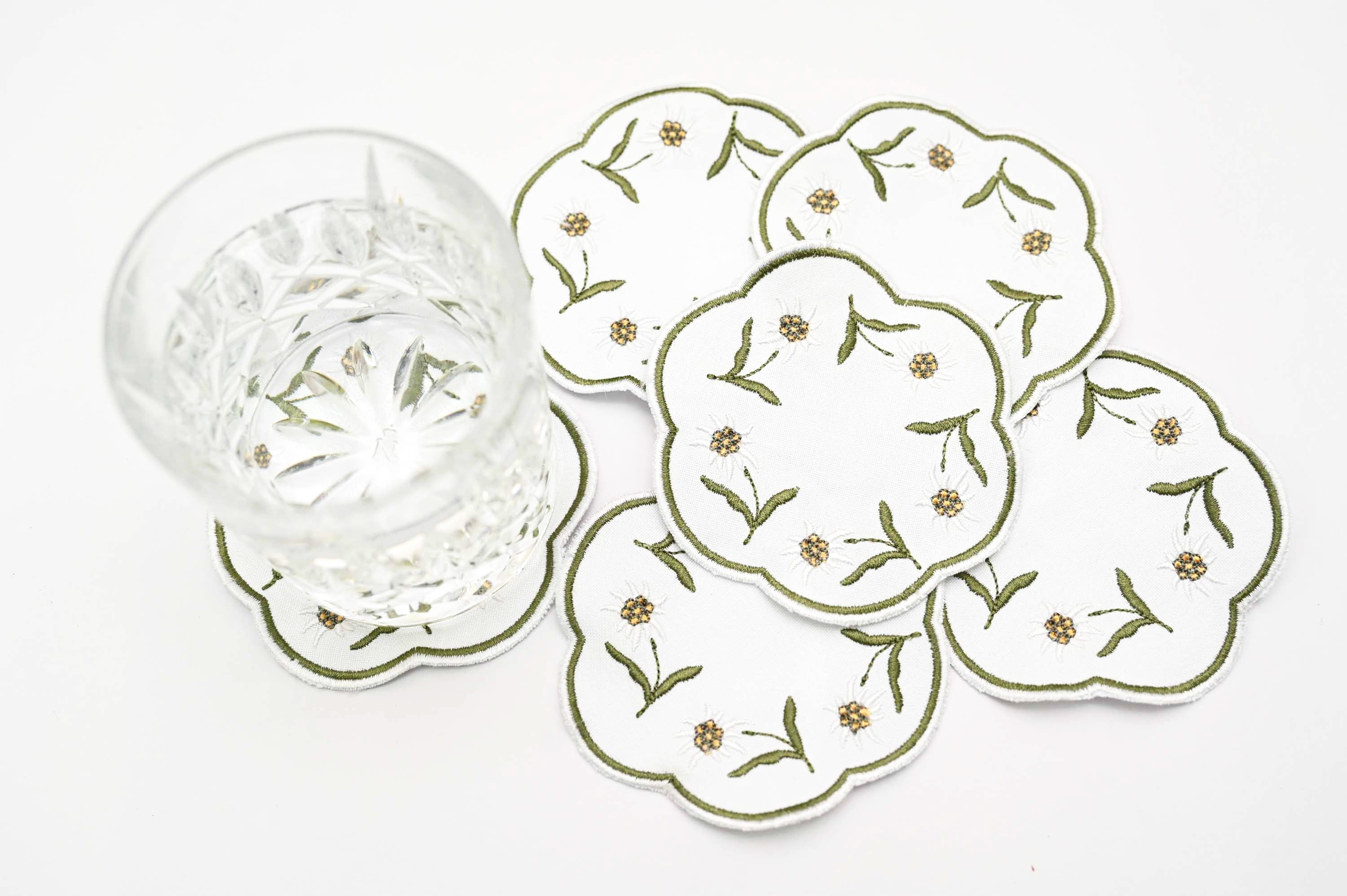 White linen round embroidered coasters.