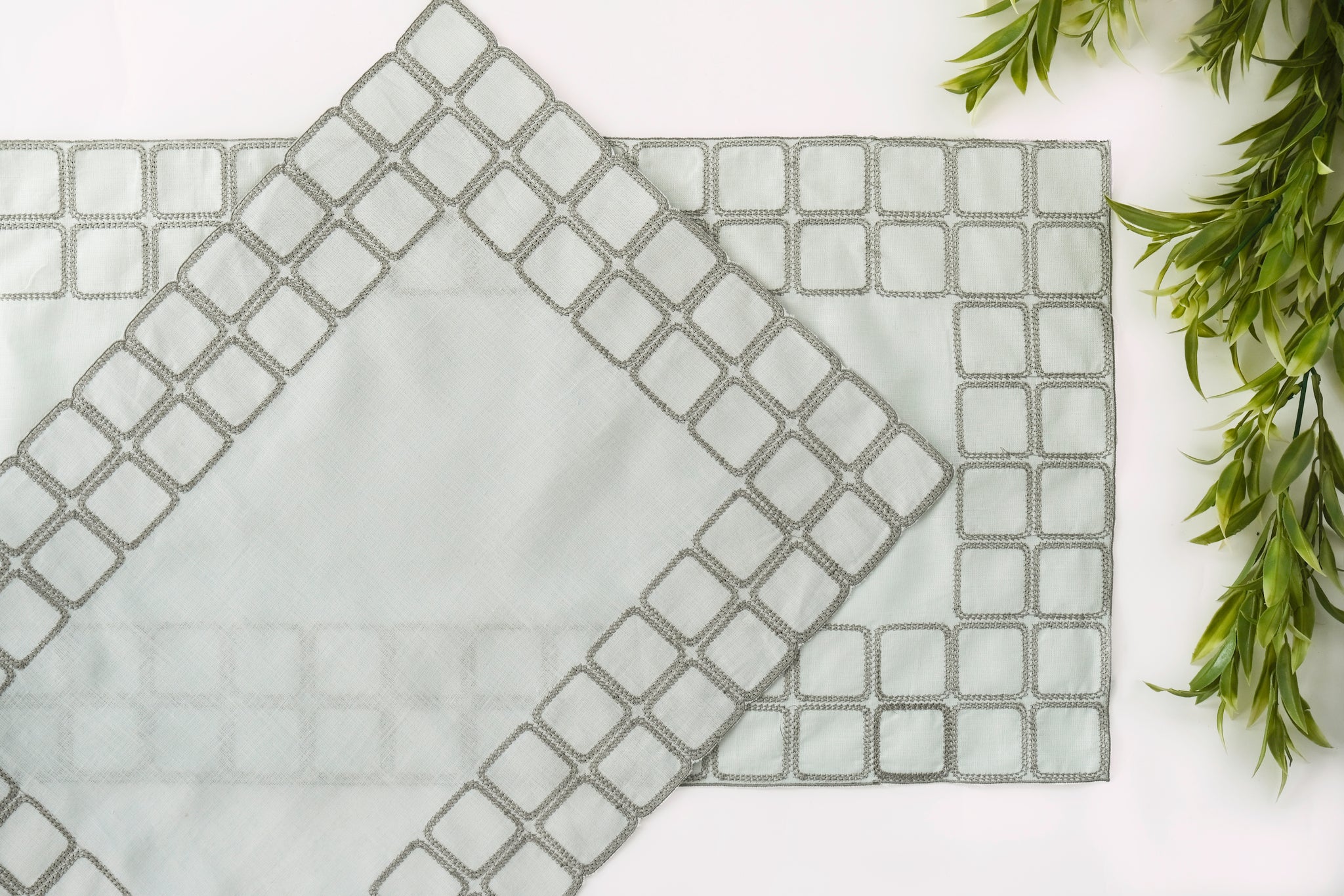 Powder blue embroidered placemats with matching linen napkins.