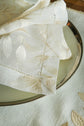 Cream embroidered linen placemats with  embroidered white napkins.