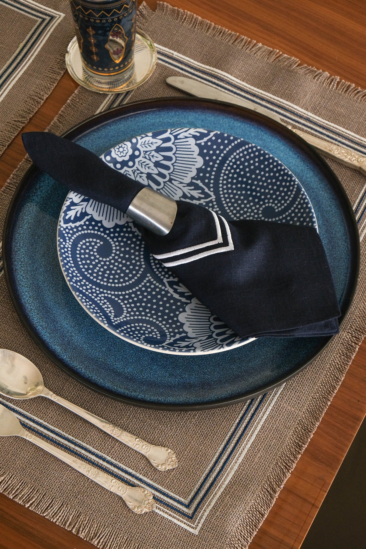 Grey linen placemats with navy blue  linen napkins.