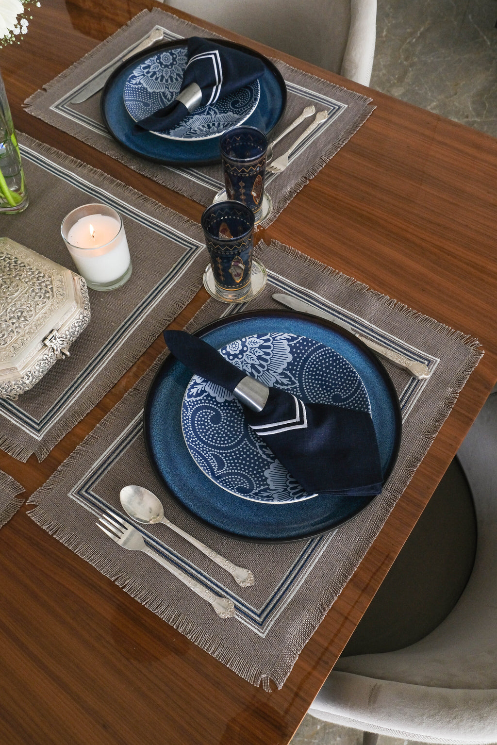 Grey linen placemats with navy blue  linen napkins.