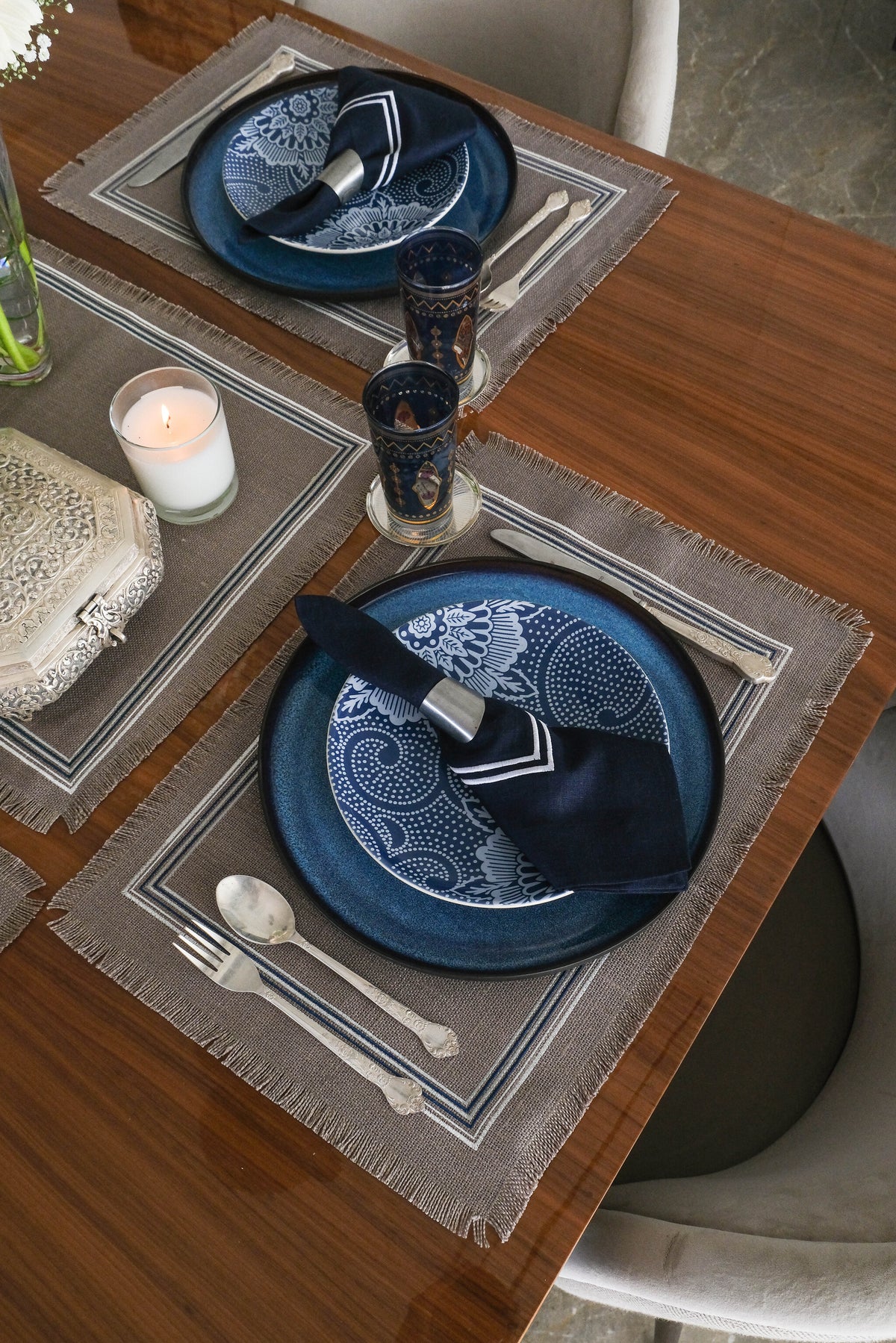 Grey linen placemats with navy blue  linen napkins.